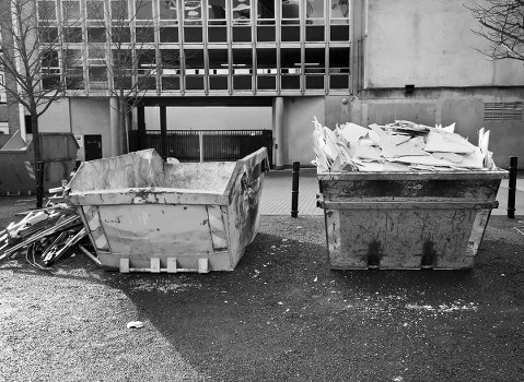 Skips of different sizes on a suburban street in Willesden