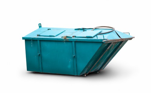 Workers loading waste into a skip outside a Willesden property