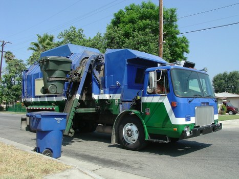 Truck delivering a skip at a residential site