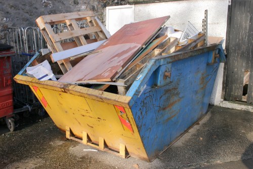 Front view of a Willesden street with a skip parked at the curb