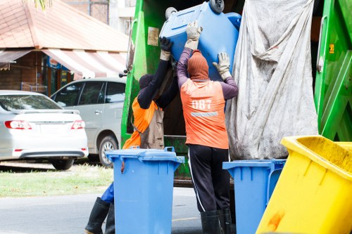 Electric low-emission van used for skip collections in an urban neighbourhood