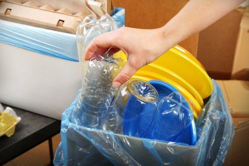 Homeowners organizing waste in a grab hire skip
